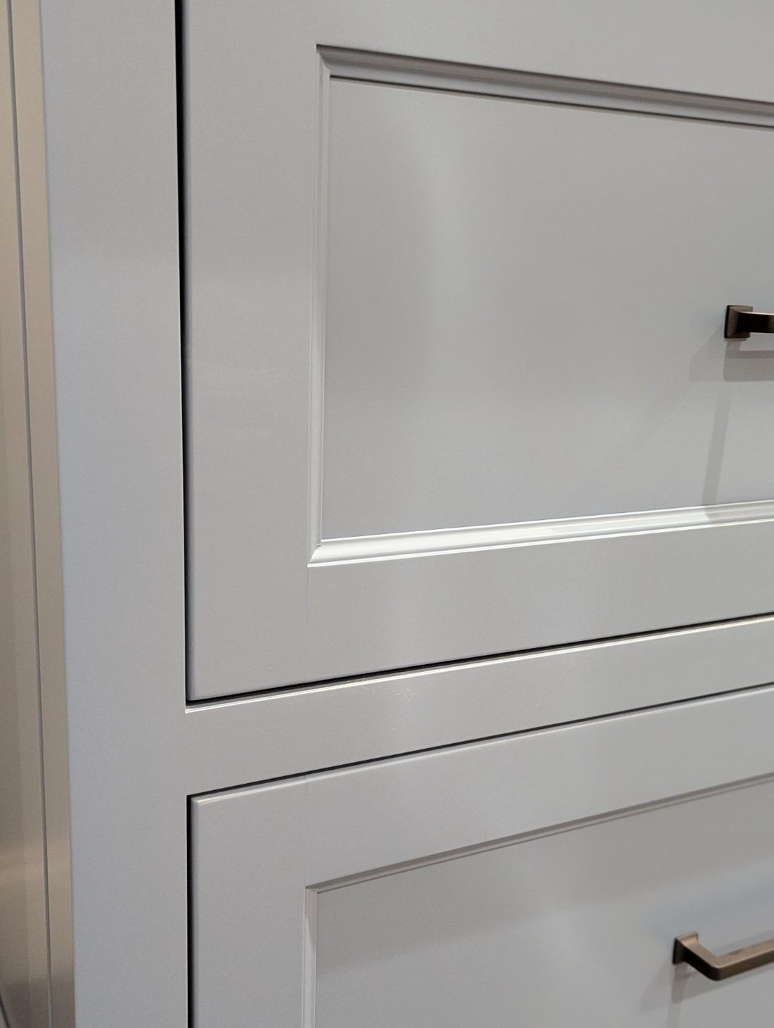 White inset cabinet drawers showing tight even reveals around each drawer front