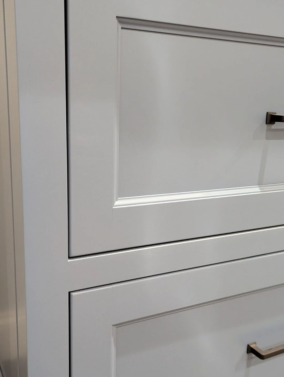White inset cabinet drawers showing tight even reveals around each drawer front
