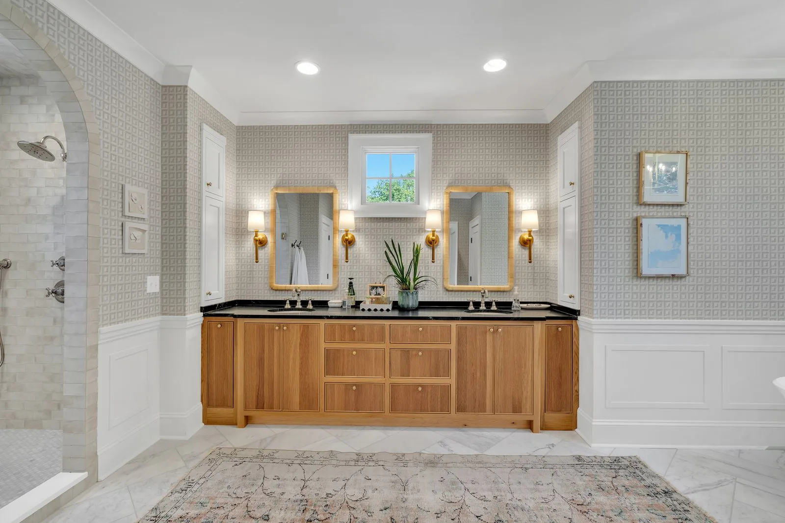 Double vanity in wood with paired mirrors and brass sconces