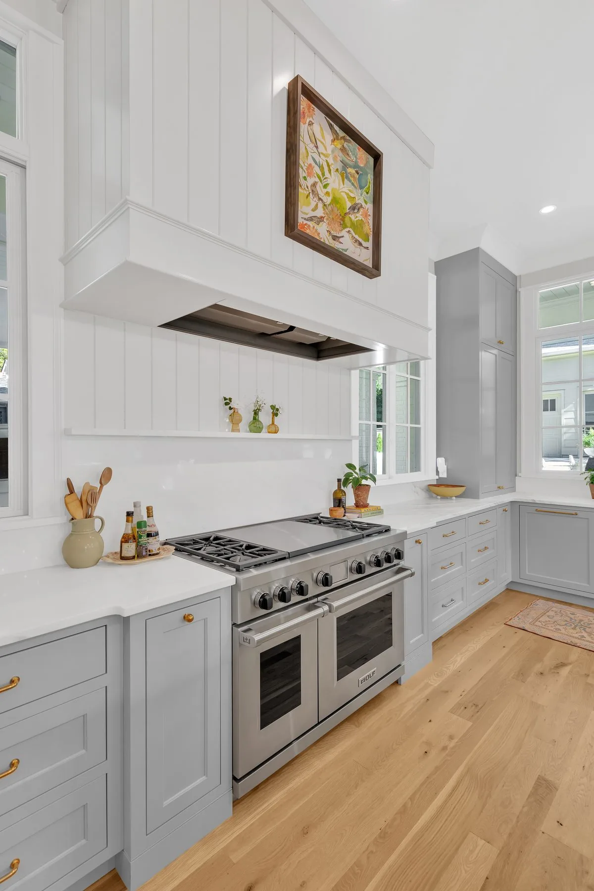 Grey kitchen range wall with a paneled hood and open shelf