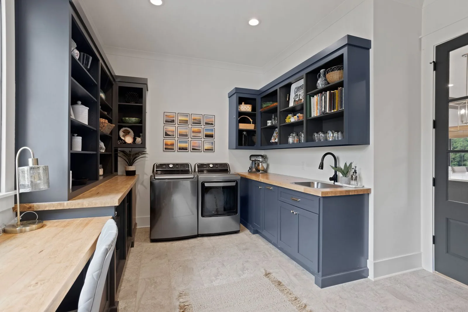 Slate blue laundry room with open shelving and a built-in desk